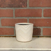 White pot with arrow line design